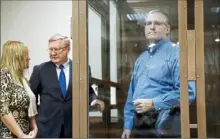  ?? Pavel Golovkin/Associated Press ?? Paul Whelan, a former U.S. Marine arrested in Moscow at the end of last year, looks through his glass cage as his lawyers talk Tuesday in a Moscow courtroom.