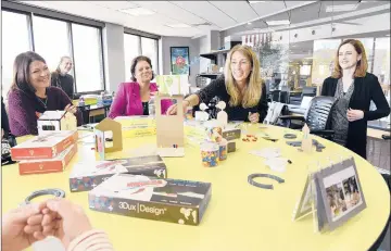  ?? CLOE POISSON | CPOISSON@COURANT.COM ?? MARCI KLEIN, second from right, talks to a group about 3Dux|Design, which she co-founded with her children, at a skillUP session run by Untapped Potential Inc. at the Farmington Library's makerspace. At right is Kathy Hazel of Untapped Potential.