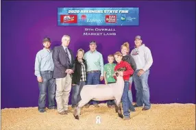  ?? COURTESY PHOTOS ?? Farmington FFA member Cordin Young with his premium sale market lamb at the 2020 Arkansas State Fair.