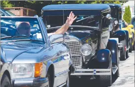  ?? JOE FRIES/The Okanagan Weekend ?? Members of local car clubs cruise Friday past Village by the Station in Penticton during a mobile show that spanned the South Okanagan.