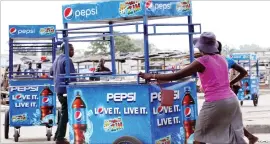  ??  ?? Pepsi Cola vendors push their carts into Renkini long distance Bus Terminus recently. The company has introduced high visibility vendors to boost sales of their products