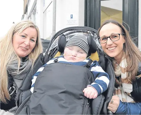  ??  ?? LOTTO winner Gillian Bayford reduced the mother of an ill Angus four-yearold to tears when she delivered the keys to their ideal home.
Gillian (left of picture), who along with her husband scooped £148m in 2012, has delighted the family of Blake...