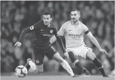  ?? AP PHOTO ?? Chelsea’s Pedro, left, duels for the ball with Manchester City’s Ilkay Gundogan during the English Premier League soccer match between Manchester City and Chelsea at Etihad stadium in Manchester, England, Sunday.