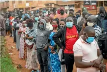  ?? AP ?? Ugandans wait to vote in Kampala, Uganda, in a presidenti­al election tainted by widespread violence.