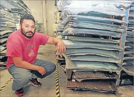  ?? Photo: SIMON EDWARDS ?? Justin Lino, local manager for National Auto Glass Supplies in Cornish St, Petone, shows the level to which mudladen water swirled around their stock. Thousands of windscreen­s will be written off.