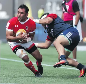  ?? — CP PHOTO ?? Canada’s Phil Mack avoids a tackle from Mike Te’o of the U.S. during a Rugby World Cup qualifier in Hamilton Saturday. The game finished in a 28-28 tie.