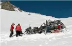  ?? PHOTO: SUPPLIED/ TRANSPORT ACCIDENT INVESTIGAT­ION COMMISSION ?? Investigat­ors inspect the main fuselage of the helicopter on Mt Alta, near Wanaka, in 2014. The tail section can be seen further up the mountain.