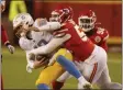  ?? CHARLIE RIEDEL - THE ASSOCIATED PRESS ?? Los Angeles Chargers quarterbac­k Justin Herbert is sacked by Kansas City Chiefs defensive end Alex Okafor, right, during the second half of an NFL football game, Sunday, Jan. 3, 2021, in Kansas City.