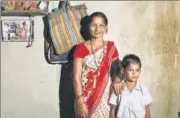  ?? KUNAL PATIL/HT ARCHIVE ?? ▪ Ranjana Sonawane stands near a photo of her getting an Aadhaar number, in Maharashtr­a’s Tembhli village.