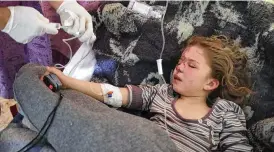  ?? AP ?? Jana al-Abdo, 7, who was pulled from under the rubble following a 50-hour rescue operation after an earthquake hit Syria and Turkey, receives treatment at a hospital run by the Syrian American Medical Society near the Syrian border with Turkey.