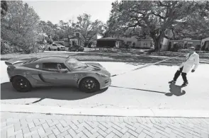  ?? JEFFEREE WOO/TAMPA BAY TIMES VIA AP ?? Dentist Mike Foley pulls a car with his teeth at his Tampa, Fla., residence Feb. 17.