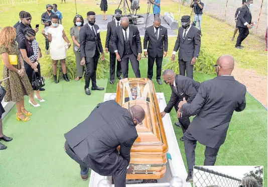  ??  ?? Pall-bearers lower the coffin bearing the body of late reggae icon Frederick ‘Toots’ Hibbert during Sunday’s interment service at National Heroes Park in Kingston. Hibbert, 77, died at the University Hospital of the West Indies in St Andrew on September 11. JIS