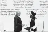  ?? HUSSEIN SAYED/AP ?? U.S. peace envoy Zalmay Khalilzad, left, and Taliban Mullah Abdul Ghani Baradar after signing a peace deal Feb. 29.