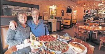  ?? [FRED SQUILLANTE/DISPATCH] ?? Owners Charlotte and Doug Vickers with some of the dishes at Vick’s Gourmet Pizza