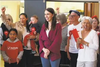  ?? Michael Bradley / AFP / Getty Images ?? New Zealand Prime Minister Jacinda Ardern visits Labor Party election day volunteers in Auckland. Ardern has won praise for her handling of the coronaviru­s pandemic.