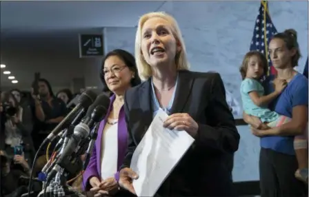  ?? J. SCOTT APPLEWHITE — THE ASSOCIATED PRESS ?? Sen. Kirsten Gillibrand, D-N.Y., with Sen. Mazie Hirono, D-Hawaii, left, joined by former students from Holton Arms School, speaks to reporters in support of professor Christine Blasey Ford, who is accusing Supreme Court nominee Brett Kavanaugh of a decades-old sexual attack, during a news conference on Capitol Hill in Washington, Thursday.