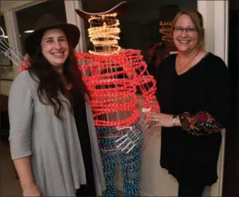  ?? RONALD W. ERDRICH — THE ABILENE REPORTER-NEWS VIA ASSOCIATED PRESS ?? Luci Wedeking, left, the Cowboy Country Museum director, and curator Jewellee Kuenstler stand beside “Windy Bill” at the museum’s entrance last week in Stamford, Texas.