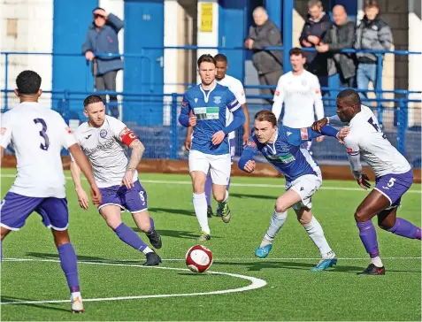  ?? ?? Leek’s Will Saxon looks for a way through against Ramsbottom. Pictures by Pete Stonier