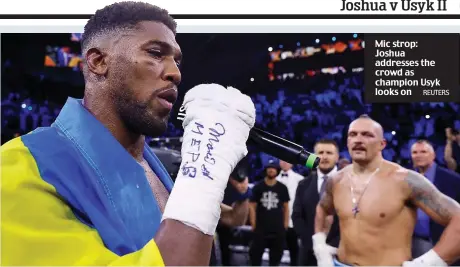  ?? REUTERS ?? Mic strop: Joshua addresses the crowd as champion Usyk looks on