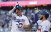  ?? JAE C. HONG ASSOCIATED PRESS ?? Dodgers left fielder Joc Pederson, left, celebrates his home run with Max Muncy during the first inning of Game 1 of a National League Division Series against the Atlanta Braves on Thursday in Los Angeles.