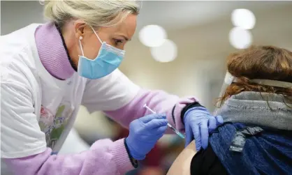  ??  ?? ‘The message for vaccinated people is to change nothing.’ A doctor injects the Covid-19 vaccine to local residents at Lords’ Cricket Ground, London. Photograph: Jed Leicester/Rex/Shuttersto­ck