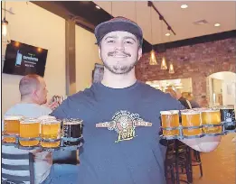  ?? PHOTO BY STEVE MACNAULL ?? Cellarman Bobby Vigil serves up craft flights during the Arizona Brewery Tour’s stop at The Beer Research Institute.