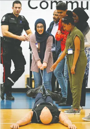  ?? LARRY WONG ?? Misk Al Fadli pulls a 68-kilogram mannequin as part the Police-youth Engagement Program along with 50 other teens who are recent arrivals from such countries as South Sudan, Somalia, Syria and Iraq.