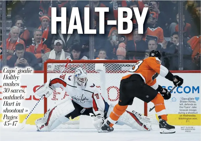  ?? MATT SLOCUM — THE ASSOCIATED PRESS ?? Caps goalie Braden Holtby, left, defends as the Flyers’ Jake Voracek misses during a shootout on Wednesday. Washington won, 2-1.