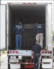  ?? JERRY LARA / SAN ANTONIO EXPRESS-NEWS ?? The trailer, which had an Iowa license plate but no other markings, was parked on the side of the Walmart. It might have held as many as 100 people during its journey, officials said.