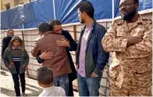  ?? — AFP ?? Mourners embrace each other after the explosion in the eastern city of Benghazi on Wednesday. The death toll following a double car bomb attack in the Libyan city of Benghazi night rose to at least 34, a hospital spokeswoma­n said