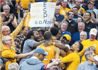  ?? AP PHOTO/DARRYL WEBB ?? Tennessee players go into the crowd to celebrate their win over Gonzaga on Sunday in Phoenix. The Vols moved to No. 3 in the Associated Press poll.