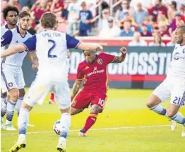  ?? CHRIS DETRICK/AP ?? Real Salt Lake forward Joao Plata, center, kicks around Orlando City SC midfielder Scott Sutter, right, during the Lions’ 1-0 win at at Rio Tinto Stadium in Sandy, Utah, Friday.