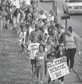  ?? THE COMMERCIAL APPEAL FILES ?? Students, parents and teachers from Balmoral Ridgeway Elementary School walk down Ridgeway Road to celebrate Internatio­nal Walk to School Day, Oct. 7, 2015. Nearly half the students gathered to skip, march and dance their way as part of a movement for year-round safe routes to school.