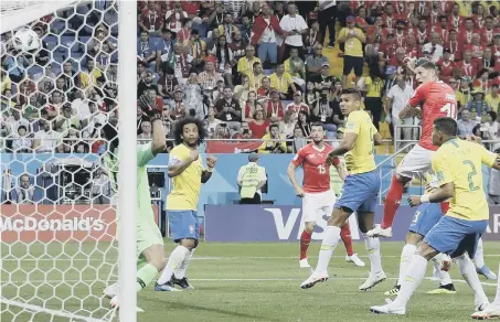  ??  ?? Steven Zuber rises to head home Switzerlan­d’s equaliser against Brazil in last night’s 1-1 draw.