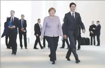  ?? Ap photo ?? German Chancellor Angela Merkel, left, and the Prime Minister Justin Trudeau arrive for a news conference after talks at the chanceller­y in Berlin.