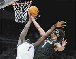  ?? AP photo ?? Boise State’s O’Mar Stanley (left) and Colorado’s J’Vonne Hadley battle for a rebound during the first half of the Buffaloes’ 60-53 win in an NCAA Tournament First Four game Wednesday.