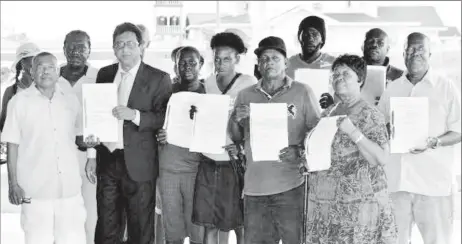  ??  ?? Some of the Number 40 Village, West Coast Berbice rice farmers whose leases were cancelled by the president with their attorney, Anil Nandlall, who successful­ly challenged some of the cancellati­ons.