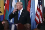  ?? EVAN VUCCI — THE ASSOCIATED PRESS ?? President Donald Trump sips from a glass after giving a toast during a luncheon at the United Nations Tuesday.