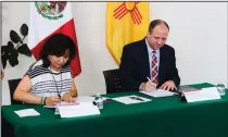  ?? (AP/Albuquerqu­e Museum Foundation/Nora Vanesky) ?? Mexican Consul Norma Ang (left) and Andrew Rodgers, president and CEO of the Albuquerqu­e Museum Foundation, sign the paperwork to return a dozen Mexican antiquitie­s back to the country.