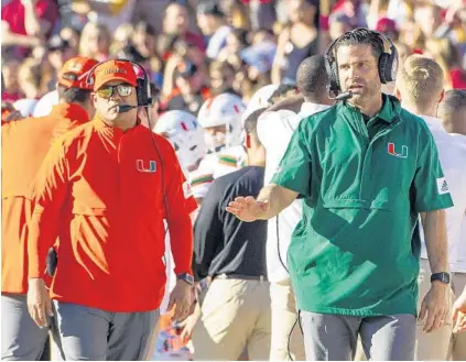  ?? MARK WALLHEISER/AP ?? Miami coach Manny Diaz, right, began spending more time with the Hurricanes defense after it gave up 42 points to Virginia Tech. His interventi­on has gotten things back on track and it likely saved the ’Canes’ season, as they have gone 3-1 since losing that Oct. 5 game to the Hokies.