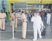  ?? AFP ?? A passenger wearing a protective outfit arrives at the Kamaraj domestic airport in Chennai, India, yesterday.