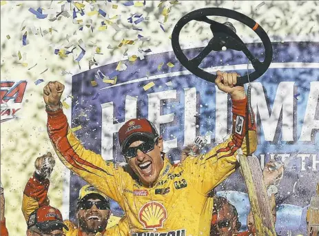  ??  ?? Joey Logano celebrates after winning the NASCAR Sprint Cup Series race Sunday at Talladega Superspeed­way in Talladega, Ala.