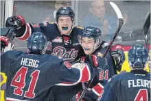  ?? JONATHAN HAYWARD
THE CANADIAN PRESS ?? Host Pats forward Sam Steel, second from left, celebrates his goal against the Hamilton Bulldogs with his teammates in third-period Memorial Cup semifinal action in Regina on Friday night.