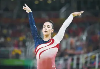  ?? (Dylan Martinez/Reuters) ?? ALY RAISMAN COMPETES on the beam during the women’s team final at the Olympics in Rio de Janeiro in 2016.