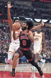  ?? DAVID BANKS/USA TODAY SPORTS ?? Atlanta Hawks forward De'Andre Hunter, left, defends against Bulls guard Coby White (0) during Wednesday's game in Chicago.