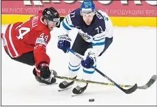  ?? (AFP). ?? Canada’s defender Morgan Rielly (left), vies with Finland’s forward Leo Komarov during the gold medal game Finland vs Canada at the 2016 IIHF Ice Hockey
World Championsh­ip in Moscow on May 22.