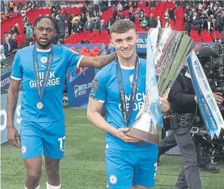  ?? ?? Harrison Burrows with the EFL Trophy and his fellow Academy graduate Ricky-Jade Jones. Photo Joe Dent/theposh.com