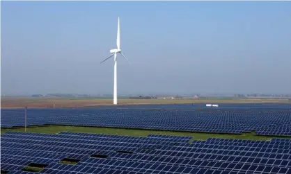  ?? Photograph: Paul Marriott/Rex/Shuttersto­ck ?? A wind turbine and a solar farm in Cambridges­hire. Some cabinet members believe the Ukraine crisis has made green energy sources all the more important.