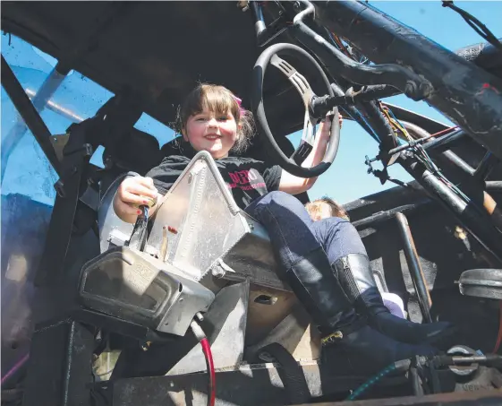  ?? Picture: GLENN HAMPSON ?? Issabella Jones gets behind the wheel of monster truck ‘Scruffy’ ahead of this weekend’s Gold Coast Car Show at Mudgeeraba Showground.