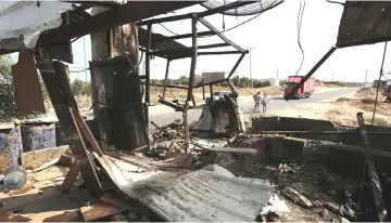  ??  ?? Palestinia­n workers inspect a Hamas observatio­n point targeted by Israeli tank fire yesterday on the eastern outskirts of Gaza City, near the border with Israel. — AFP photo